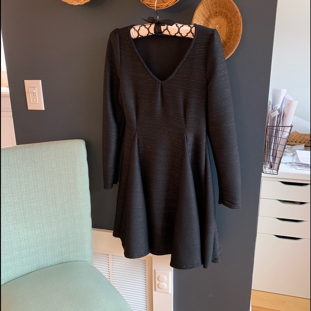 Long sleeve black dress. Shimmering threads.